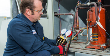 Technician working on HVAC equipment