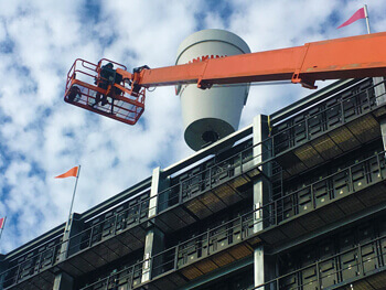 Special projects team member on a crane assisting a client on a custom valve project