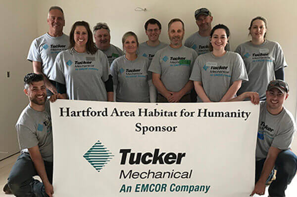 Team of Tucker workers volunteering with Habitat for Humanity